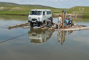 A mongóliai Darhad-völgyben egy régészeti expedíció tagjai egy fából készült kompon kelnek át a folyón