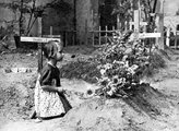 Kislány a varsói Mazowiecka utca melletti temető egyik sírhantja előtt térdepel (1944)